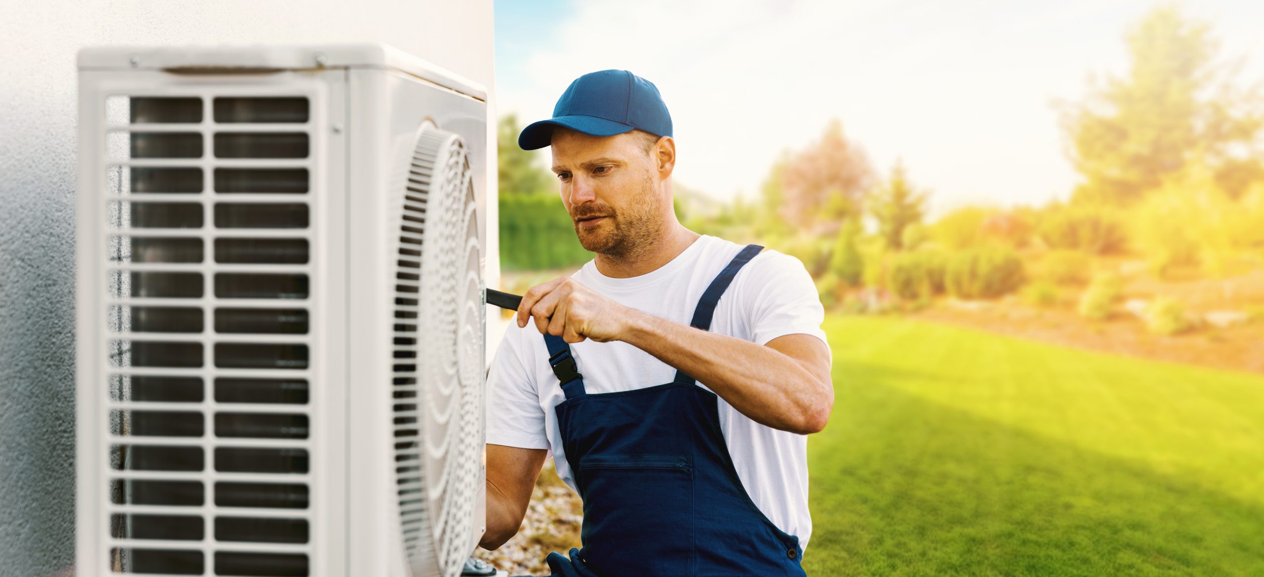 Technician repairing a home air conditioning or heat pump outdoor unit for Air & Plumbing Systems Inc