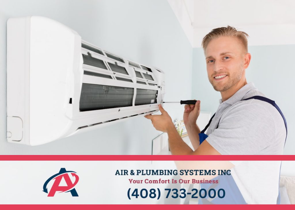 Technician repairing a residential air conditioner - top 5 signs your AC needs repair this summer with Air & Plumbing